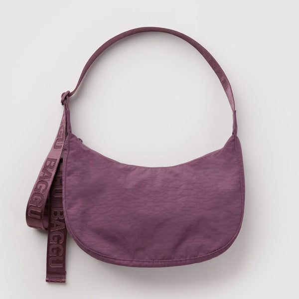 Dusky purple nylon crescent crossbody bag against a white background.
