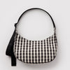 A black and off-white gingham crescent-shaped shoulder bag with a black strap, shown against a plain light gray background.
