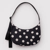 A nylon crescent bag in black with off-white polka dots against a white backdrop.