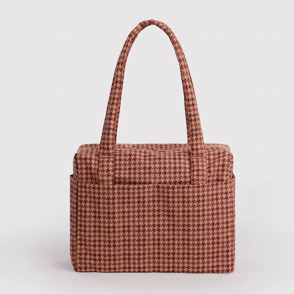 A tan and brown houndstooth nylon carry-on bag against a white background.