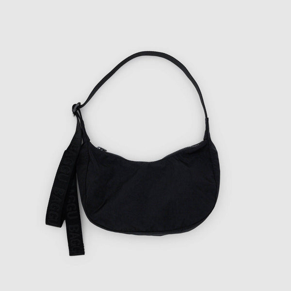A small black nylon crescent crossbody bag against a white background.