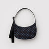 A small nylon crescent bag in black with light blue mini polka dots against a white backdrop.
