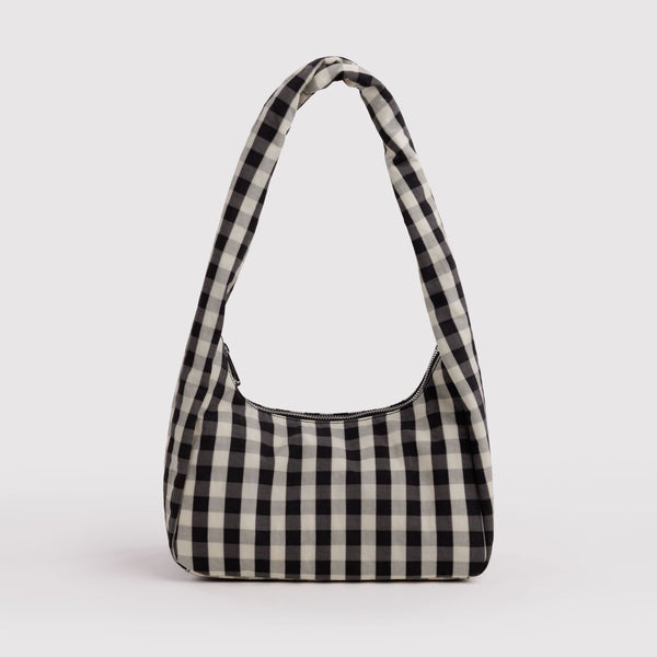A small nylon shoulder bag in a black and off-white gingham print on a white background.