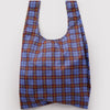 A nylon shopping bag in a rich blue, maroon, and golden yellow tartan plaid print against a white backdrop.