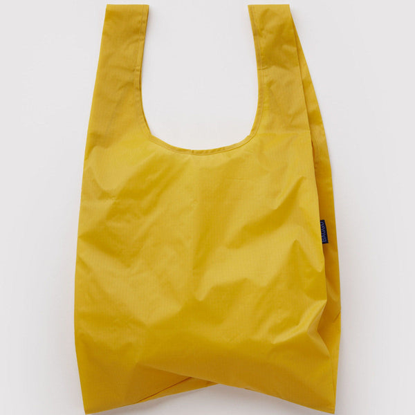 Bright sunflower yellow reusable bag on white background.