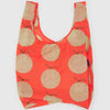 A bright orange reusable bag with a pattern of melons against a white background.