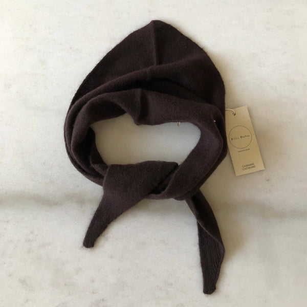 A brown-black fuzzy cashmere-wool blend triangle cravat scarf looped against a white marble backdrop.