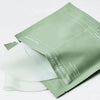 Green facial mask packaging on a white background
