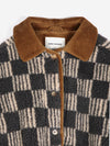 A close-up view of a beige and grey striped checkerboard fleece jacket with brown corduroy trim and collar against a white background.