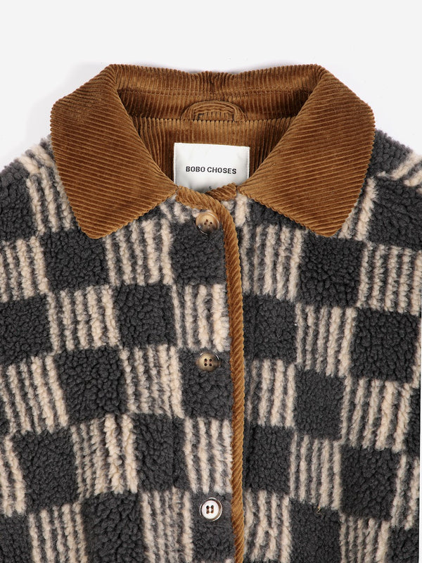 A close-up view of a beige and grey striped checkerboard fleece jacket with brown corduroy trim and collar against a white background.