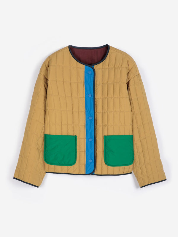 A tan, blue and green colorblock lightweight puffer jacket against a white background.