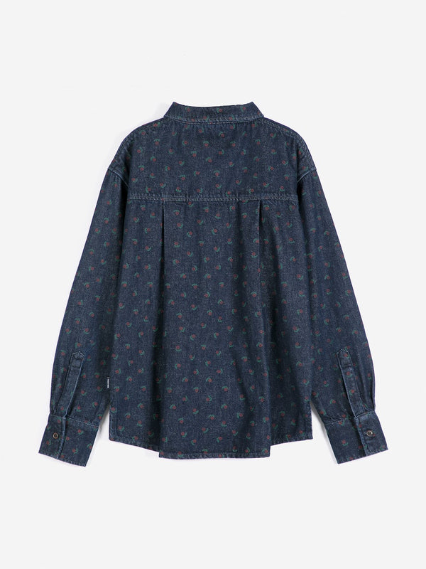 A back view of a dark wash denim shirt with a subtle floral print against a white background.
