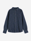 A dark wash denim collared shirt with a subtle floral print against white background.