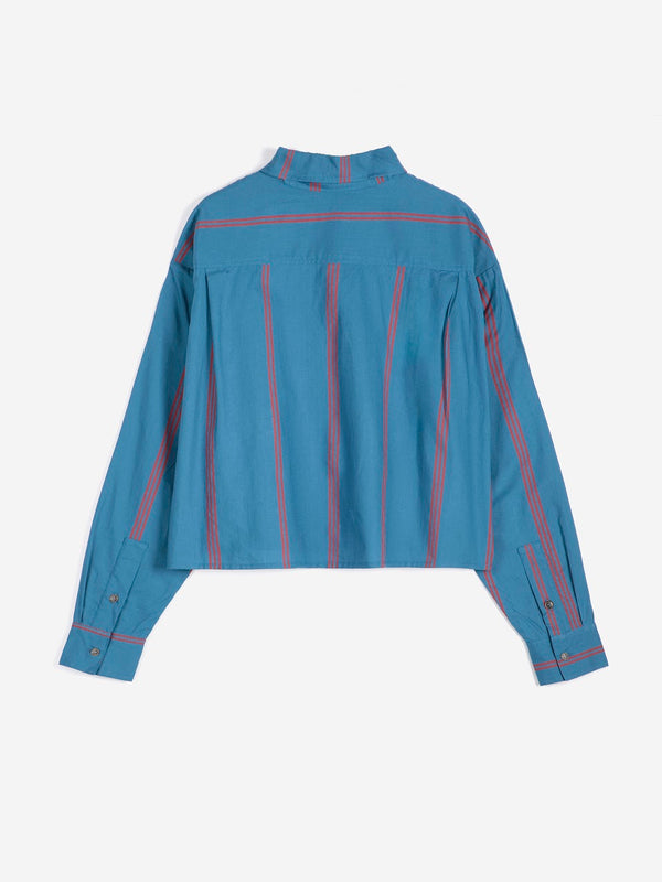 The back view of a boxy bold blue and red triple stripe poplin collared shirt against a white background.