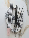 Incense sticks with packaging on a marble surface