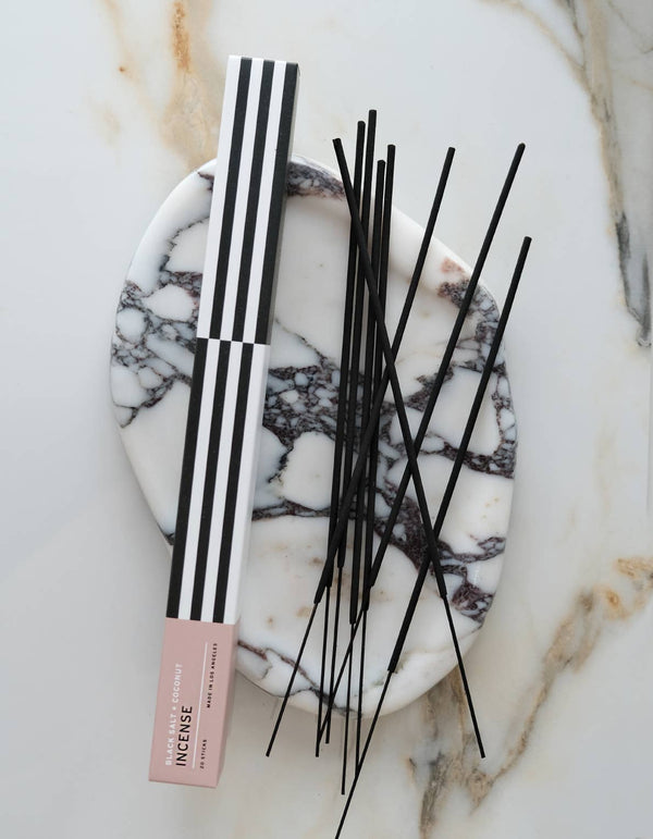 Incense sticks with packaging on a marble surface