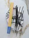 Incense sticks with a colorful packaging on a marble surface