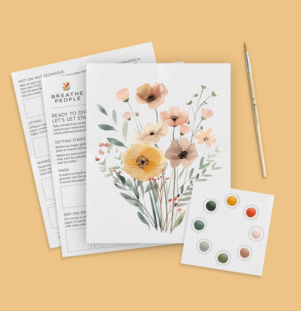 Wildflowers watercolor art kit with paint dots, brush, and instruction sheets on a yellow background.