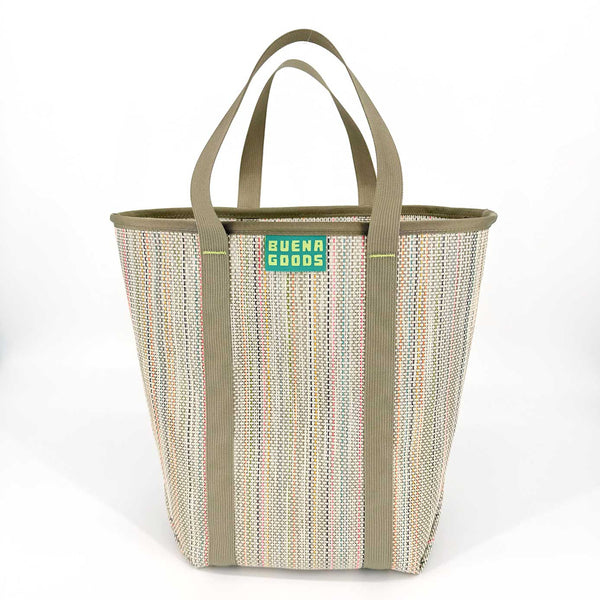 Woven tote bag with multicolored pattern and 'Buena Goods' label on a neutral background