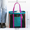 Multicolored tote bag with dimensions shown next to a person wearing jeans and boots.