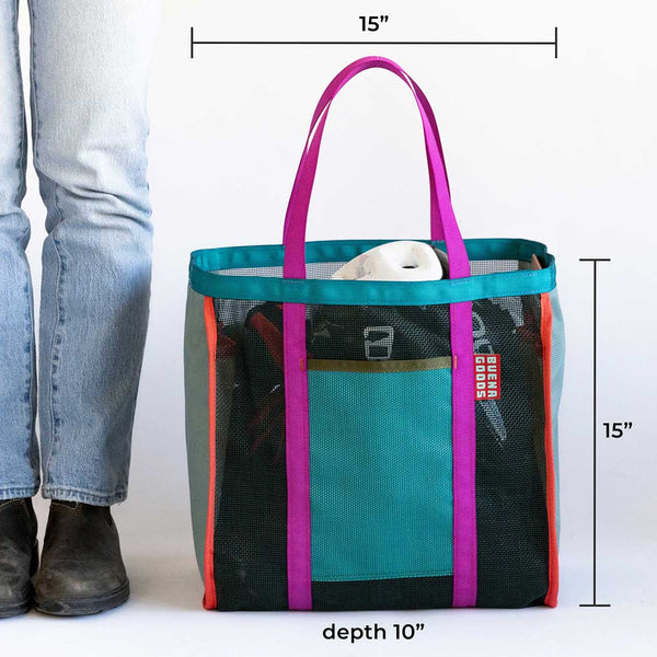 Multicolored tote bag with dimensions shown next to a person wearing jeans and boots.