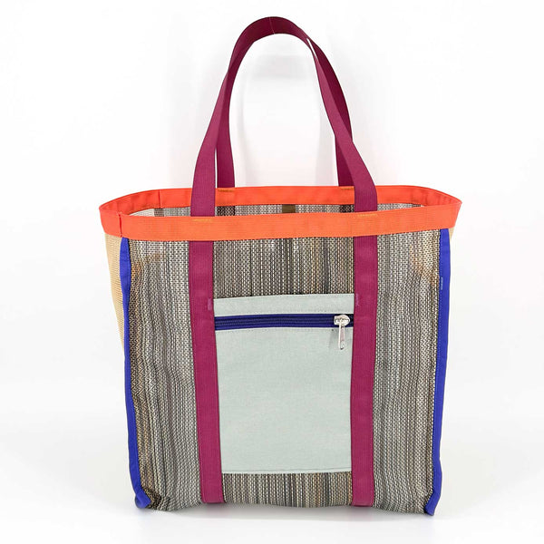 Multicolored tote bag with grey zip-top side pocket on a white background