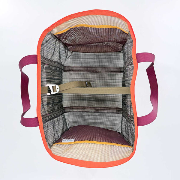 Top down view of a mesh tote bag with orange rim, maroon handles, and an olive security strap on a white background