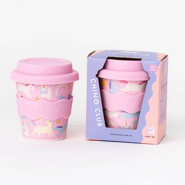 Pink reusable cup with unicorn design and matching lid, displayed with packaging on a white background.