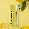 Cirque Colors nail & cuticle oil pen and packaging with yuzu fruit on a yellow background