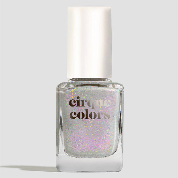 Cirque Colors white shimmergraphic nail polish bottle with a white cap on a light gray background