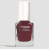 A bottle of Cirque Colors nail polish in a deep mahogany shade, featuring a white cap and clear glass bottle, set against a light gray background.