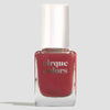 A bottle of Cirque Colors nail polish in a deep red shade, featuring a white cap and clear glass bottle, set against a solid light gray background.