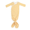 Yellow baby swaddle with smiley face pattern on a white background