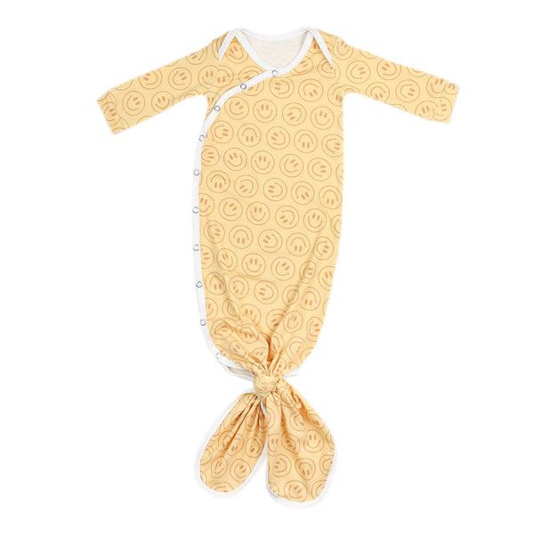 Yellow baby swaddle with smiley face pattern on a white background