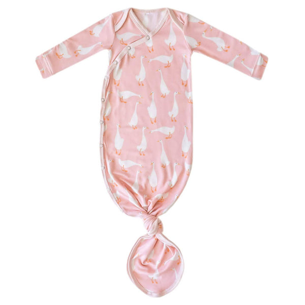 Pink baby swaddle with goose pattern on a white background