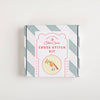 Cotton Clara cross-stitch kit packaging with striped design on a white background