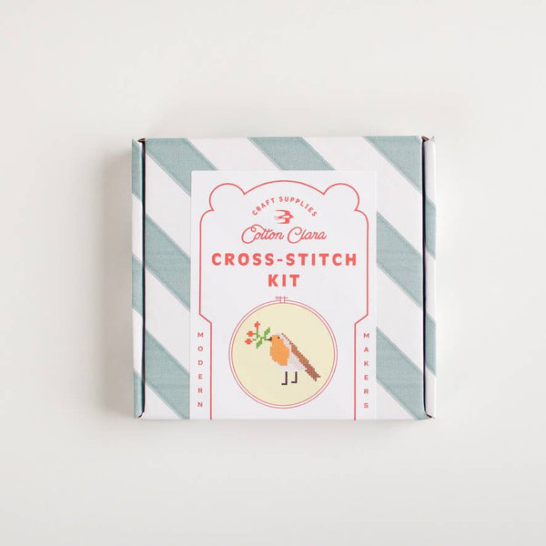 Cotton Clara cross-stitch kit packaging with striped design on a white background