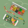 Forest-themed bracelet making kit with beads and tools on a green background