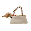 A beige canvas mini purse bag with brown handles, featuring a plush dachshund toy tucked inside the bag and a colorful patterned fabric lining visible at the opening.