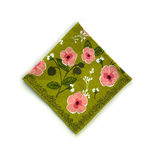 Floral patterned napkin with pink flowers on a green background