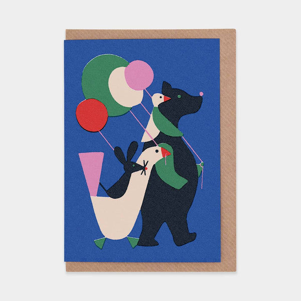 A blue greeting card with a bear, duck, goose, and mouse marching with colorful balloons. 