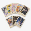 Set of tarot cards with various designs and symbols on a white background