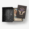 Interior view of a tarot deck box showing a guidebook and cards.