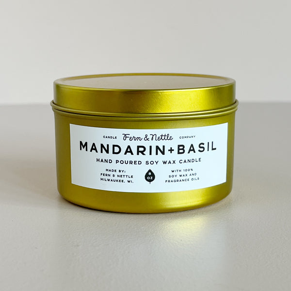 Gold candle tin with a label on a white background