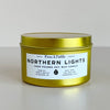 Gold candle jar with 'Northern Lights' label on a light gray background