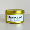 Gold candle tin labeled 'Golden Hour' by Fern & Nettle on a light background