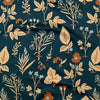 A detailed view of a kitchen towel in navy with a botanical print in tan, orange, and light blue.