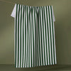 Green and white striped towel hanging on a line against a green background