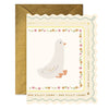 Scalloped die-cut greeting card with a goose illustration accented by florals and the repeating text 'Sweet little one' with a decorative gold envelope on a white background