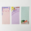 Three illustrated notepads featuring cats and a plant on a white background